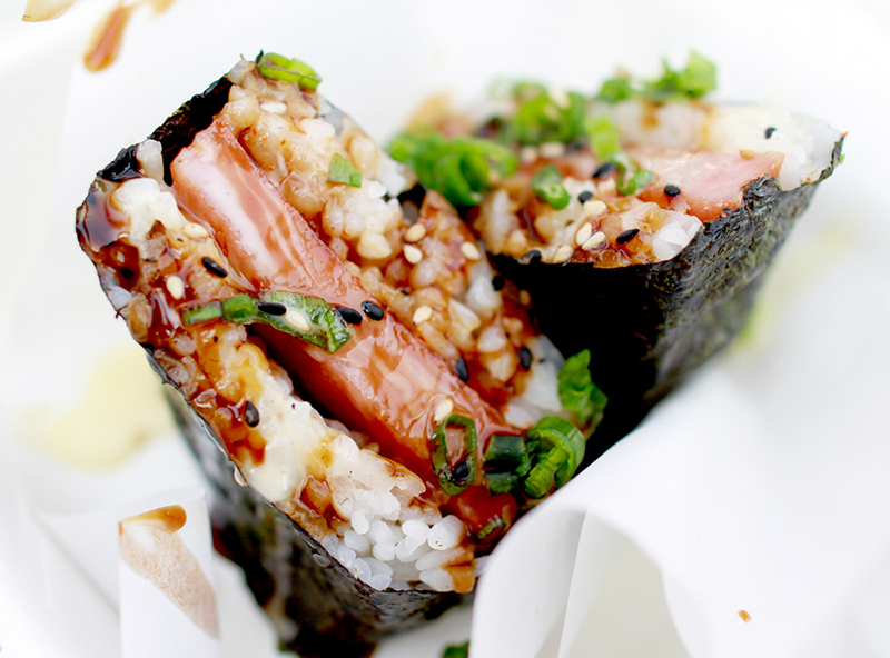 Spam musubi is a popular snack and lunch food in Hawaii composed of a slice of grilled Spam on top of a block of rice, wrapped together with nori dried seaweed in the tradition of Japanese omusubi.